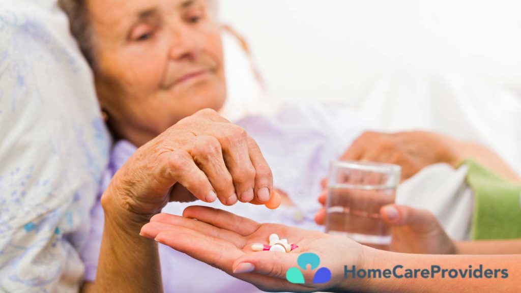 An elderly woman getting her medicine from someone's hand