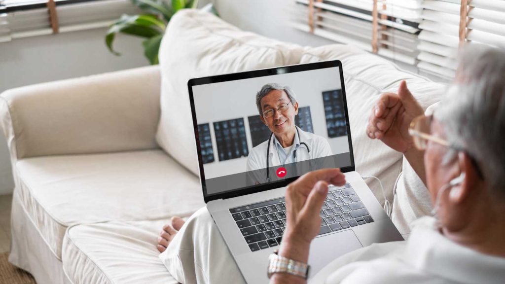 Senior having a telemedicine consultation with a doctor on a laptop