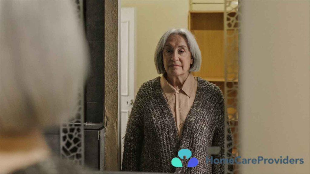 Senior woman standing in front of a mirror