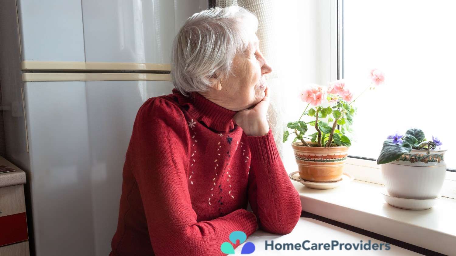 An elderly woman gazing thoughtfully out a window at home