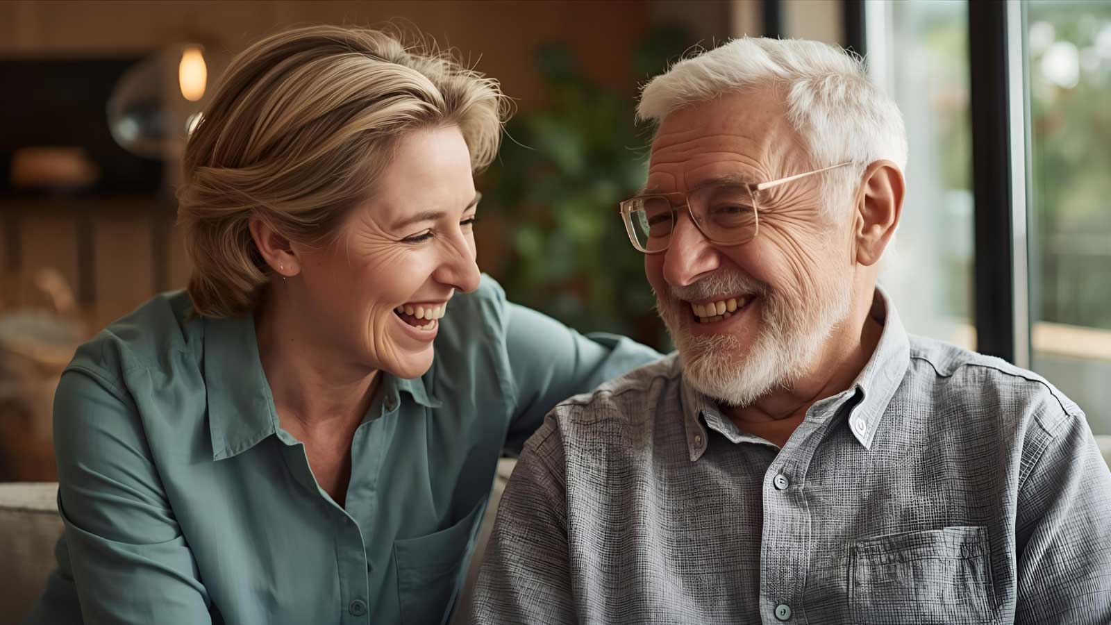 A compassionate geriatric care manager and senior client share a lighthearted moment.